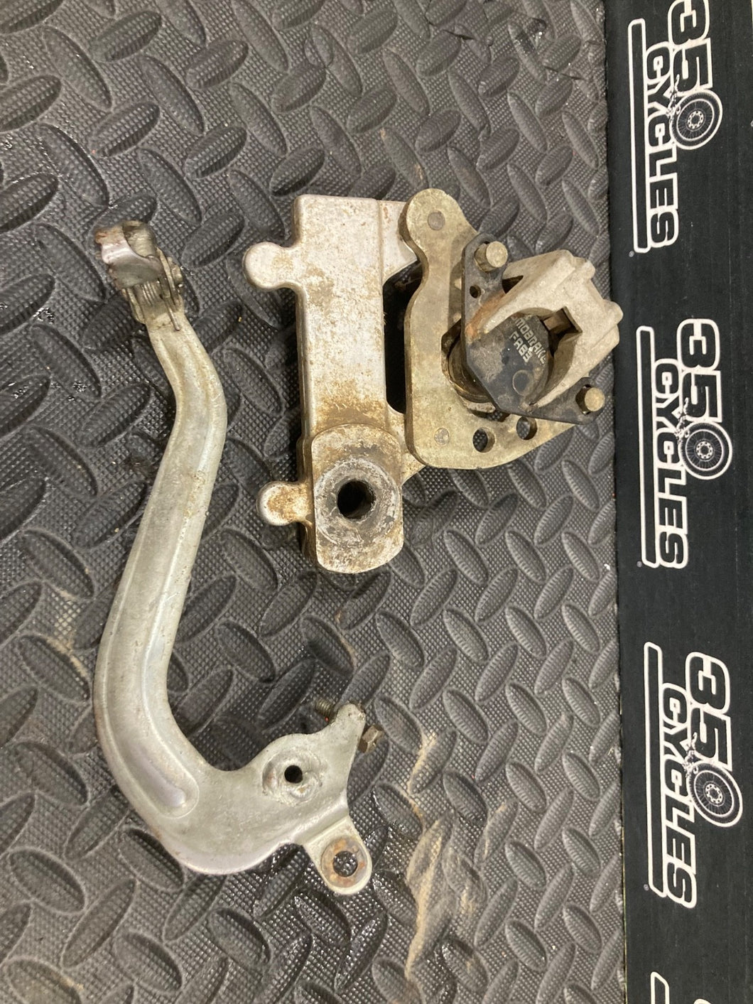 2002 02-15 RM85 RM85L OEM Rear Brake Caliper Bracket Lever